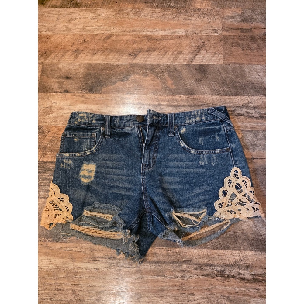 Free People Distressed Dark Blue Denim Shorts with Cream Lace Trim